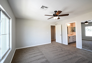 Freshly renovated bedroom with new drywall and carpeting in Hermosa Beach.